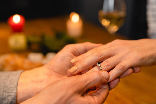 Close up photo of engagement ring on womans hand during a
date