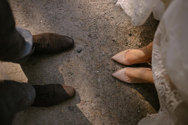 Close-up photo of the feet of the bride and groom. bride and groom in shoes.