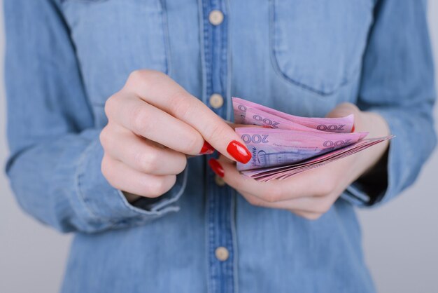 Close up photo of female hands holding money