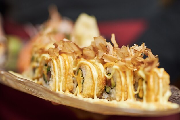 Close-up photo of fresh set of sushi tastefully dressed and served on a plate