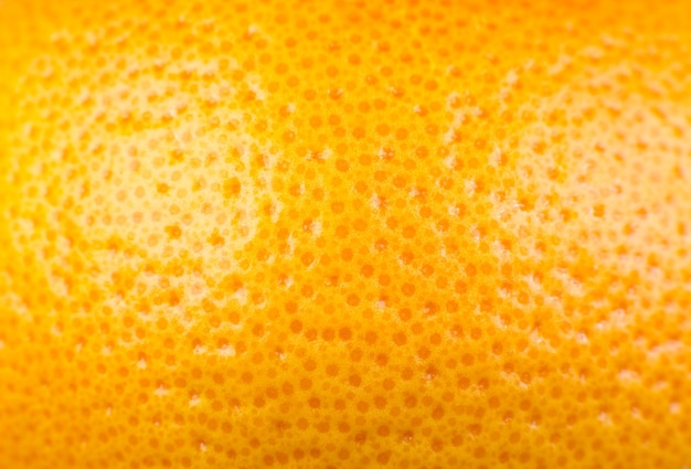 Close up photo of Grapefruit peel texture Exotic ripe fruit orange background macro view Human skin problem concept acne and cellulite Beautiful nature wallpaper