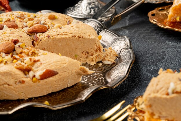 Close up photo of halva dessert on silver arabic plate