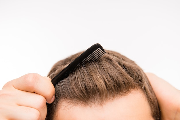 Close-up photo of a man brushing his hair