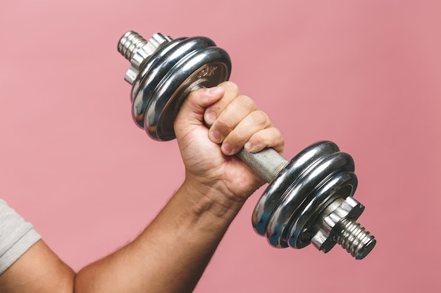 Close up photo of man grabs a heavy dumbbell