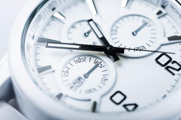 Close-up photo of metal clock on background