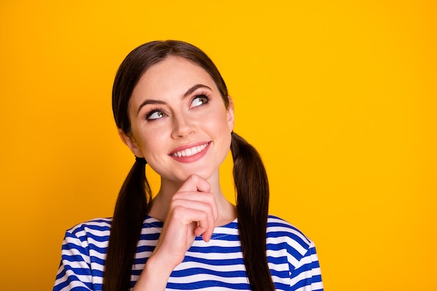 Close up photo of minded positive cheerful girl look copyspace touch chin finger think thoughts plan summer weekends wear striped blouse isolated over bright color background