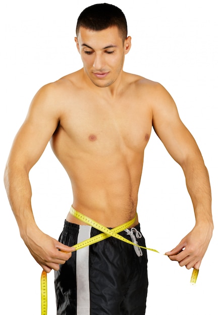 Close up photo of sportsman measuring waist with tape isolated on white background
