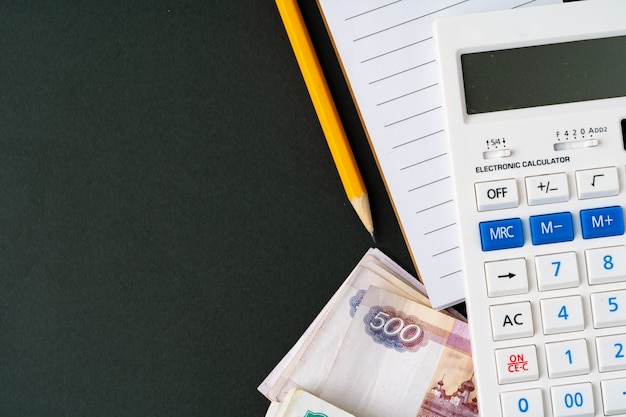 Close up photo of stack of Russian money rubles with calculator