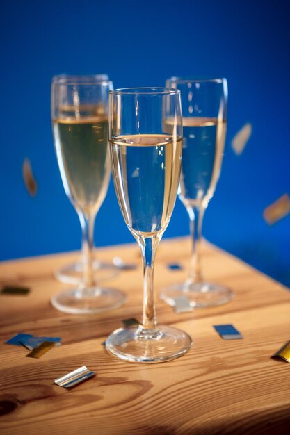 Close up photo of three glasses with champagne at party.