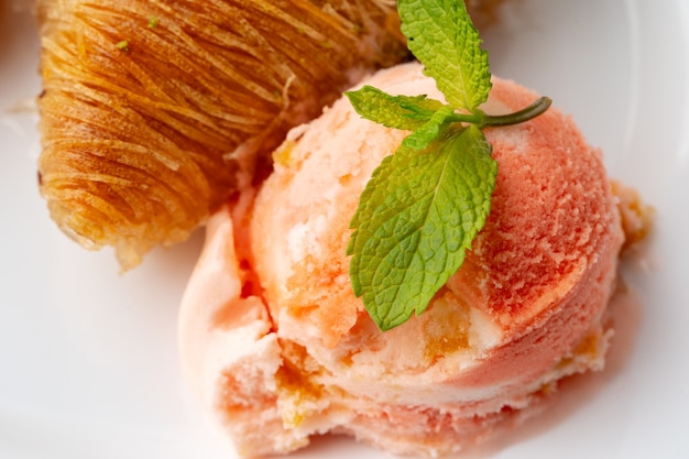 Close up photo of turkish baklava served with ice cream