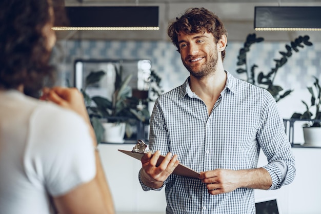 Close up photo of two male colleagues discussing project in office