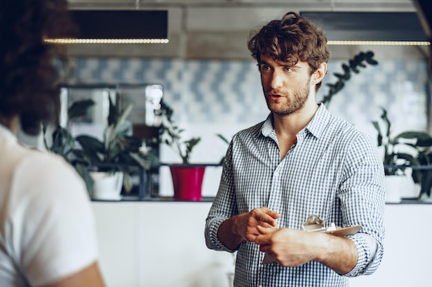 Close up photo of two male colleagues discussing project in office