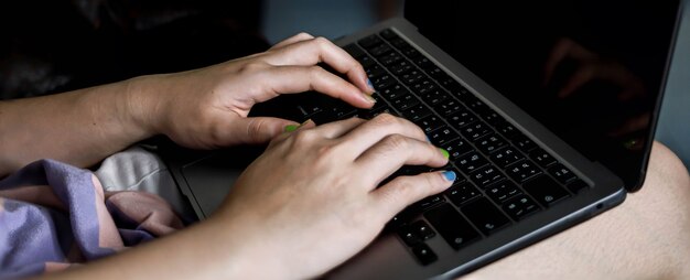 Close-up photo of typing on the keyboard, Asian woman hand typing message on laptop, Laptop typing concept.