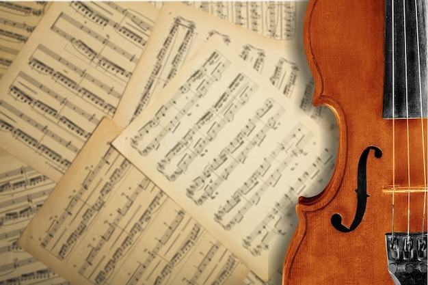 Close-up Photo Of Violin And Musical Notes