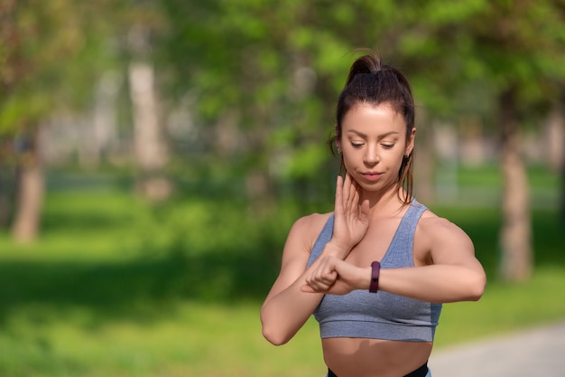 Close up photo of a woman checking her pulse during the race