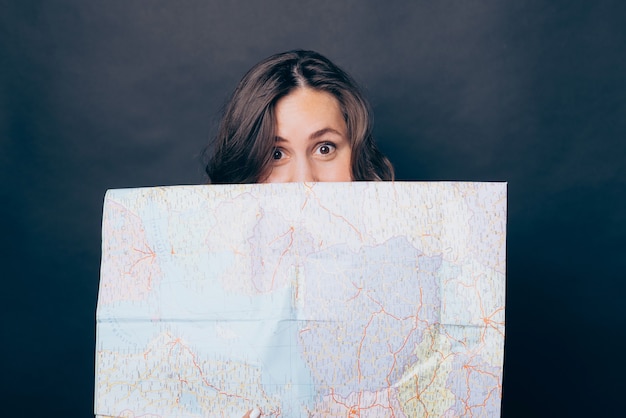 Photo close up photo of woman covering face with world map