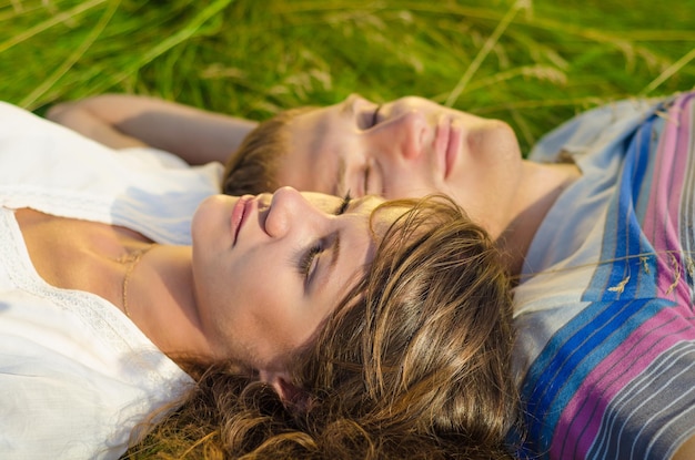 Close up photo of a young couple relaxing in the grass