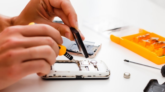 Close-up photos showing process of mobile phone repair