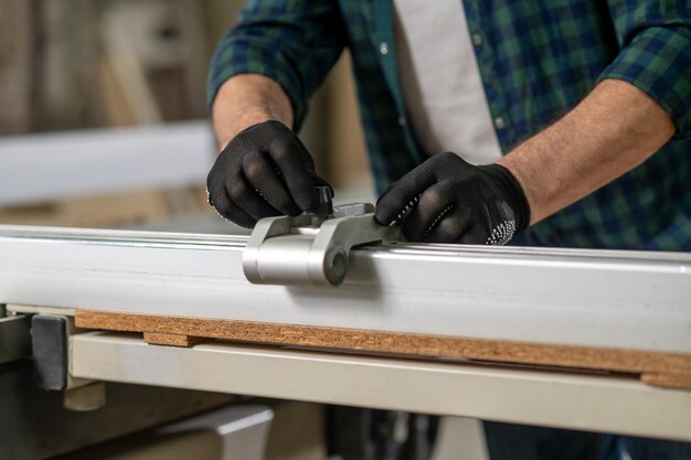 Close up picture of carpenter hewing the wood