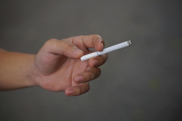 Close up picture of cigarette with hand