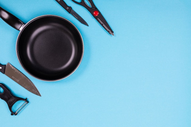 Close up picture of group of kitchen utensils on blue