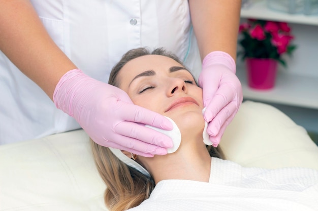 Close up picture of lovely young woman with closed eyes in beauty salon