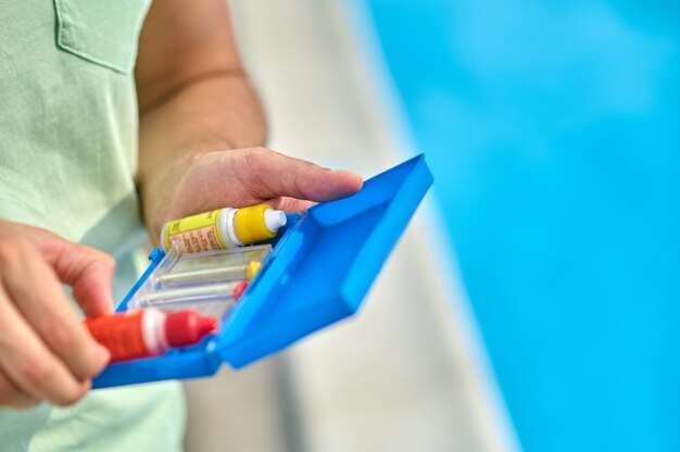 Close up picture of mans hands with water tests