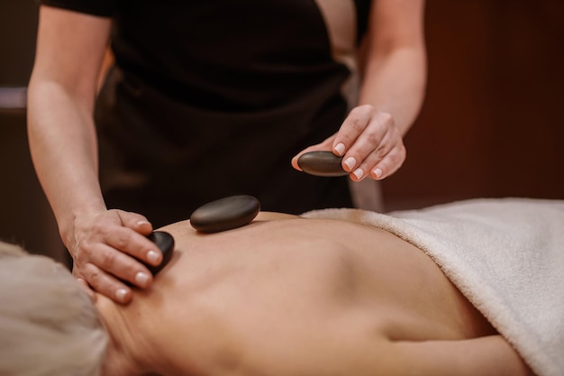 Close up picture of a woman having stone back massage