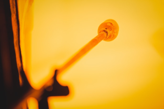 Photo close-up of a piece of glass heated in furnace