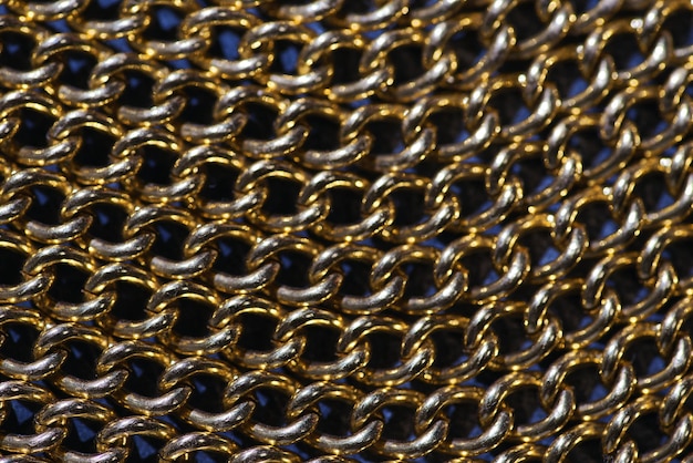 A close up of a piece of metal with a gold chain link.