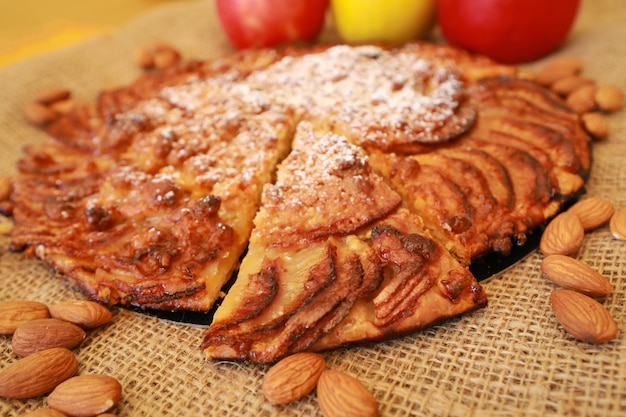 Close up on piece of sliced apple pie with nuts