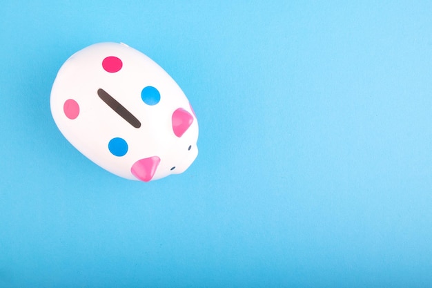 Close-up of piggy bank on blue background