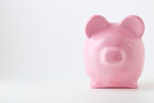 Photo close-up of piggy bank over white background