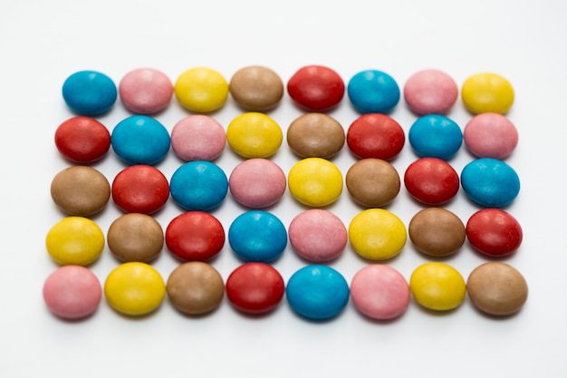 Close up of a pile of colorful chocolate coated candy, chocolate pattern, chocolate background