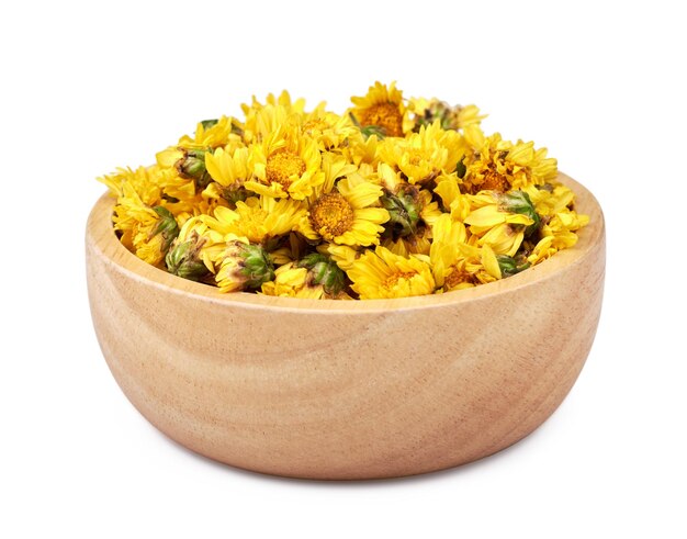 close-up of a pile of dried chrysanthemum flowers in a wooden bowl isolated white background