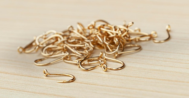 Close up Pile of fish hooks on wooden background