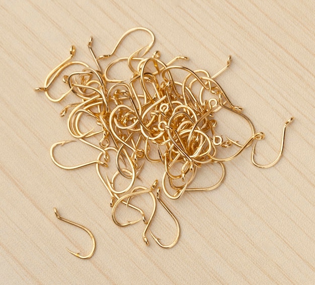 Close up Pile of fish hooks on wooden background