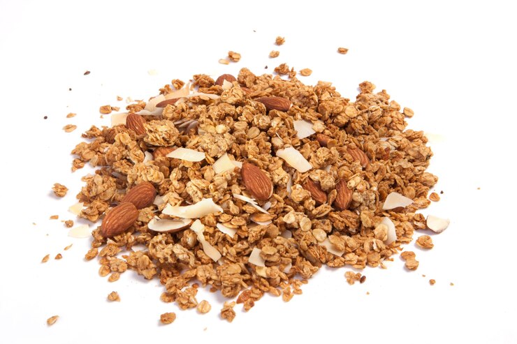 Photo close up pile granola isolated on white background.