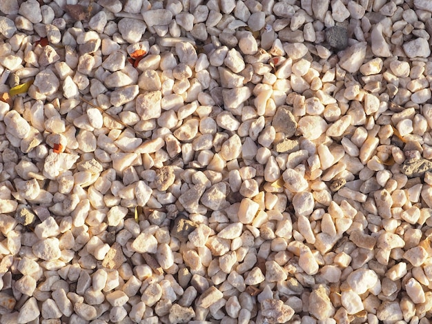 A close up of a pile of gravel with the word pebble on it.
