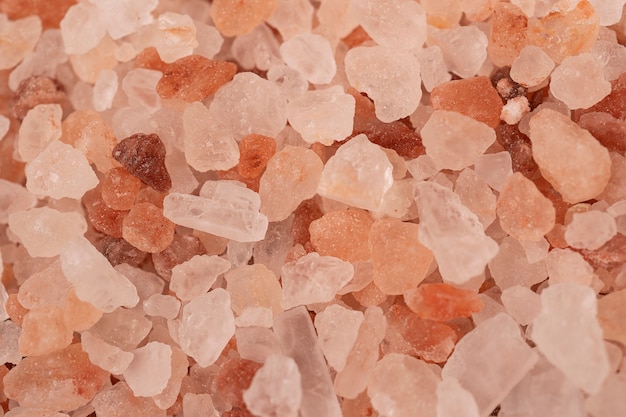 Close up a pile of Himalayan pink salt in natural light visible texture bright crystals of  salt