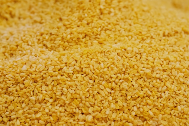 Close up pile of Yellow moong mung dal lentil pulse bean in thai street food market