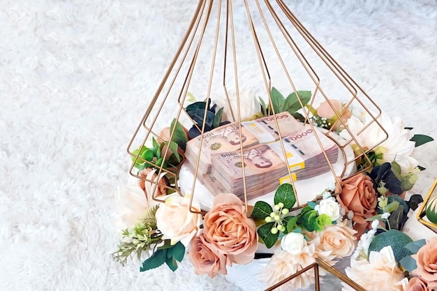 Close up of piles of Khan Mak money in a basket for thai wedding traditions