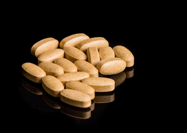 Close-up of pills against black background