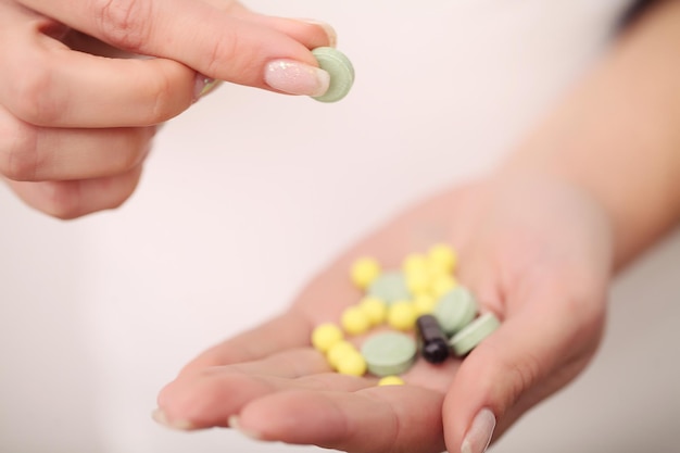Close up of pills in female hands