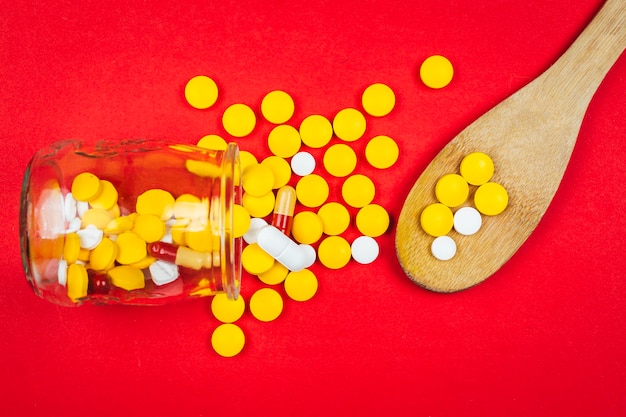 Close-up of pills over red background