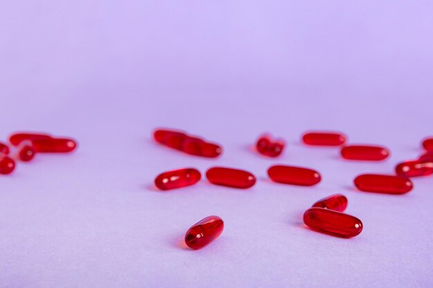 Close-up of pills spilling from bottle against white background