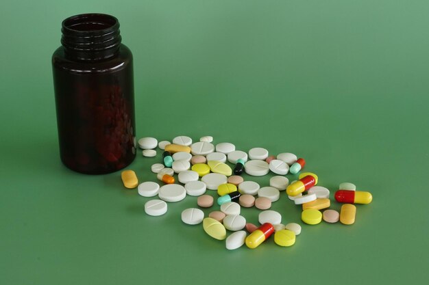 Close-up of pills spilling from bottle