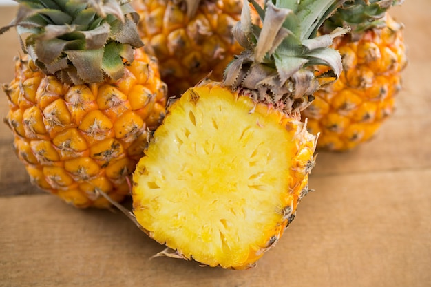 Close-up of pineapples on wooden table