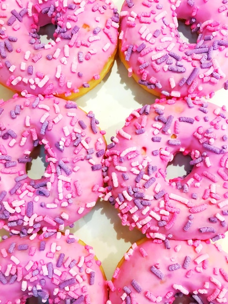 Close-up of pink donuts on table