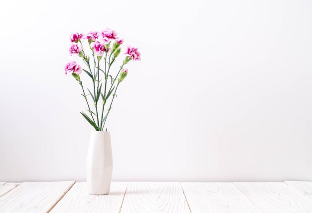 Photo close-up of pink flower vase on table against white background